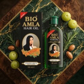 Bio Amla Herbal Hair Oil 100ml green bottle and black product box displayed with amla fruits — Chaudhary Superstore