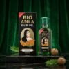 Bio Amla Herbal Hair Oil 50ml green bottle with black box on a dark green marble podium — Chaudhary Superstore
