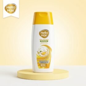 Hello Hair Egg Protein Shampoo 75ml white bottle with yellow cap on a luxury studio podium from Chaudhary Superstore