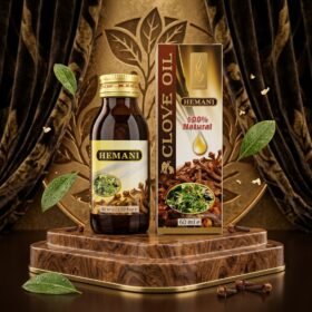 Hemani 100% Natural Clove Oil 60ml amber glass bottle and box packaging on wooden podium from Chaudhary Superstore