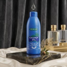 Hemani Coconut Oil 100% Natural 100ml blue bottle on luxury black marble display stand from Chaudhary Superstore