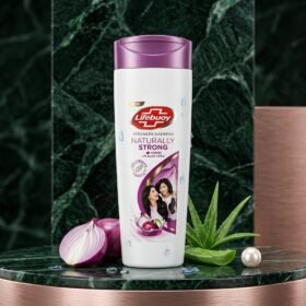 Lifebuoy Naturally Strong Shampoo 90ml bottle on a luxury green marble and golden studio podium from Chaudhary Superstore