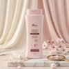 Rivaj Sakura White Body Lotion 200ml soft pink bottle on marble podium — Chaudhary Superstore