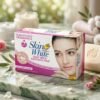 Skin White Goat Milk Whitening Soap packaging box next to a carved rose soap bar on a marble surface