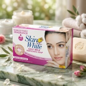 Skin White Goat Milk Whitening Soap packaging box next to a carved rose soap bar on a marble surface