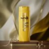 Sunsilk Silky Smooth Shampoo 185ml yellow bottle on a luxury wooden and golden studio podium from Chaudhary Superstore