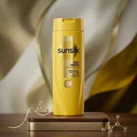Sunsilk Silky Smooth Shampoo 185ml yellow bottle on a luxury wooden and golden studio podium from Chaudhary Superstore