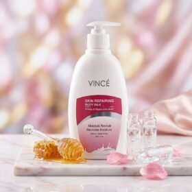 Vincé Skin Repairing Body Milk Honey & Hyaluronic Acid 330ml pump bottle on a marble podium — Chaudhary Superstore