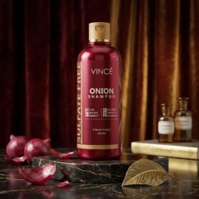 Vincé Sulfate Free Onion Shampoo Anti Flake 300ml maroon bottle displayed on a luxury studio marble block from Chaudhary Superstore